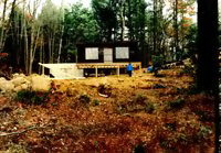 The old cabin moved onto the new foundation and framing for the porch