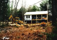 dozer & Backhoe in front of the cabin, now under roof